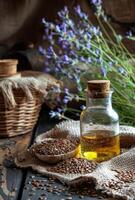 AI generated Bottle of flaxseed oil with flax seeds and flowers in the background photo