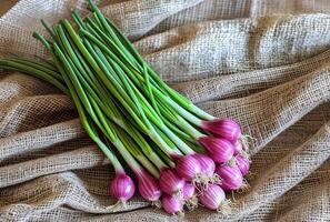 AI generated Green onions and red onions on linen cloth photo
