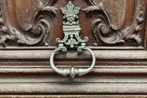 close up of the knocker on the old vintage door photo