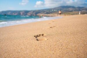 Footprints On Ocean Sandy Beach photo