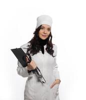 a woman in a white lab coat holding a clipboard photo