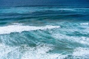 Aerial view of tropical sandy beach and ocean with turquoise water with waves. Sunny day on Atlantic ocean beach photo