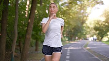 Woman running asphalt road summer park photo