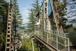 Station of the old cable car. Rust and ruin on the background of pine trees photo