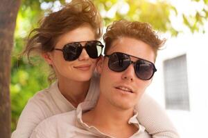 Happy cheerful couple in sunglasses photo