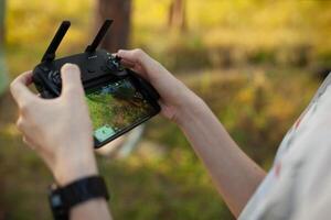 Close up of male hands operating a drone with remote control. photo