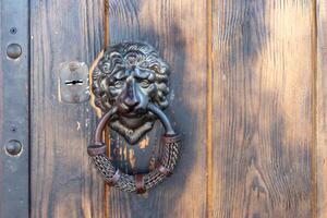 Lion head door handle on classic vintage door with copy space photo