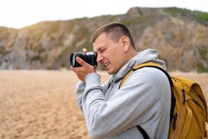 Traveler photographer takes photo beautiful seascape