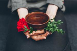 Woman offers hot tea in a vintage ceramic cup. photo