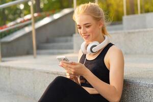 Sport and Fitness Young Adult Caucasian Woman Sitting Concrete Floor Resting after morning Workout Outdoor Summer Park photo