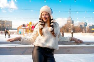 Happy winter time in big city charming girl standing street dressed funny fluffy hat. Enjoying snowfall, expressing positivity, smiling photo