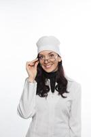 a woman in a white coat and glasses photo