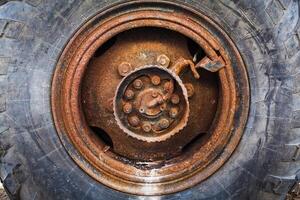 Rusted wheel of old car photo