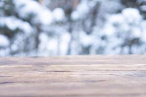 Beautiful winter scene. blurred background of snowy christmas nature background, Wood table top on shiny bokeh. For product display Christmas time mock up photo