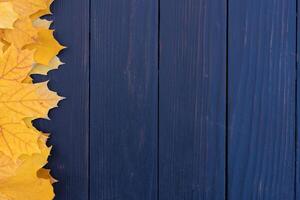 Autumn leaves frame on wooden background top view Fall Border yellow and Orange Leaves vintage wood table Copy space for text. photo