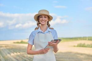 Woman farmer straw hat smart farming standing farmland smiling using digital tablet Female agronomist specialist research monitoring analysis data agribusiness photo
