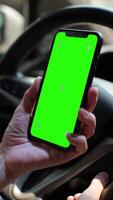 Car with phone, person using phone green screen on car video