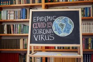 inscription stay at home. Outbreak Warning. written white chalk on blackboard in connection with epidemic of coronavirus worldwide. photo