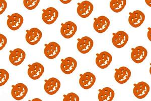Halloween pumpkins pattern. Many scary pumpkin faces background photo