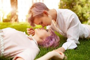 Happy playful lesbian couple in love sharing time together Women friendship concept with girls couple having fun on fashion clothes outdoors Summertime leisure. photo