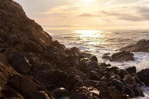 sharped rock in the sea or ocean wave photo