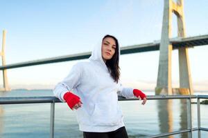 Woman boxer standing outdoor looking camera photo