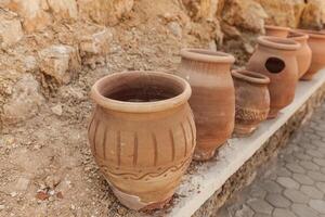 many large clay pots standing in a row photo