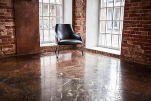 chair stands near a window on the brick wall background in the windows photo