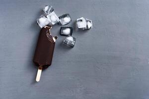 ice cream stick  on dark  background  covered chocolate sticks frozen Popsicle and Lolly sweet dessert  Flat lay photo