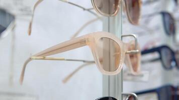 Showcase with stylish glasses and sunglasses. Optics, optical shop video