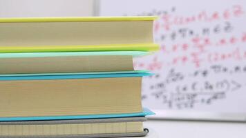 Textbooks stacked in a column rotate around its axis on a stand. Education concept video