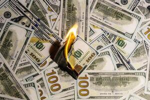 American currency banknote burns as a sign of a falling or rising currency rate photo