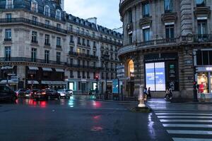 Paris, France - June 01, 2018. Paris street view with traditional french building facades under summer evening sun rays. Parisian avenue by sunset. photo