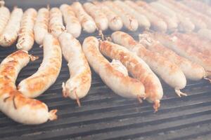 BBQ with fiery sausages on the grill photo