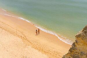 Aerial view of sea waves and sandy beach photo