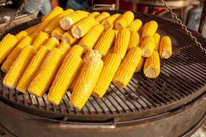 Corn on the grill. Street food. vegetarian snack. photo