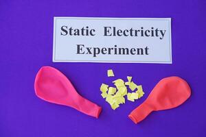 Ballons and small pieces of paper. Equipment, prepared to do experiment about static electricity. Blue background.  Concept, Science lesson, fun and easy experiment. Education. Teaching aids. photo