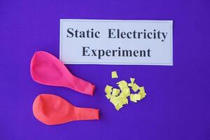 Ballons and small pieces of paper. Equipment, prepared to do experiment about static electricity. Blue background.  Concept, Science lesson, fun and easy experiment. Education. Teaching aids. photo