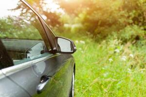 Landscape in the sideview mirror of a car , on road countryside. photo