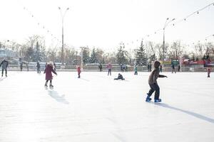 Ukraine, Kharkov 30 December 2018 People skate in the city park on Freedom Square. Excellent family leisure on weekends and holidays. photo