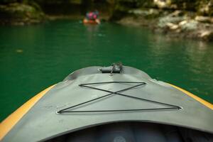 Kayaking on the river. group of people in a boat sailing along the river. Rowers with oars in a canoe. Rafting on a kayak. Leisure. photo