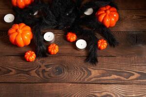 Halloween background, orange decorative plastic pumpkin black paper bat black cardboard Thanksgiving greeting card photo