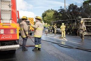 Portugal, Odivelas 07 September 2022 Rescue Team of Firefighters Arrive on the Car Crash fired passenger bus Traffic Accident Scene photo