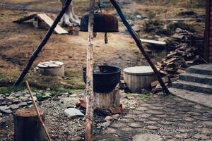 A cauldron aka caldron, large metal pot kettle for cooking or boiling over an open fire photo