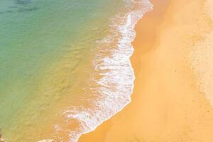 Aerial view of sea waves and sandy beach photo