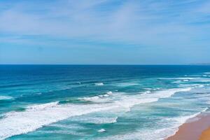 Aerial view of tropical sandy beach and ocean with turquoise water with waves. Sunny day on Atlantic ocean beach photo