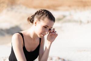 Close up portrait of a sad and depressed woman deep in thought outdoors. photo