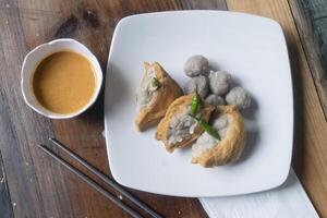 tofu and meatballs on wooden table photo