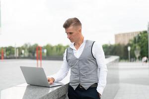 Business. Businessman Using Laptop Outdoors. Modern Technology Concept photo