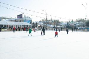 Ukraine, Kharkov 30 December 2018 People skate in the city park on Freedom Square. Excellent family leisure on weekends and holidays. photo